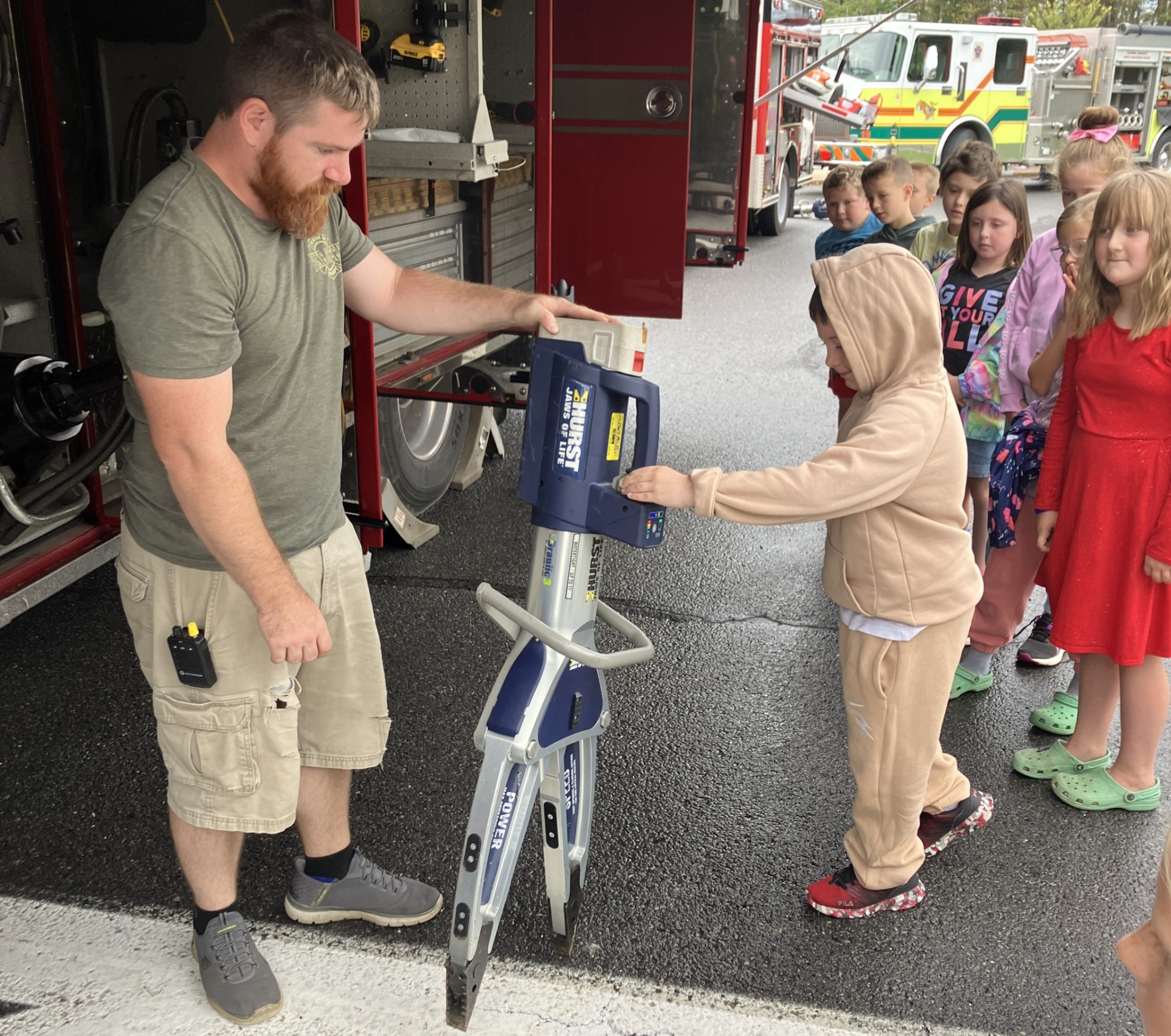 Firefighter AJ Moore and 2nd graders with the jaws of life.